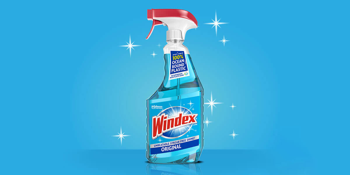 Applying window tint with Windex